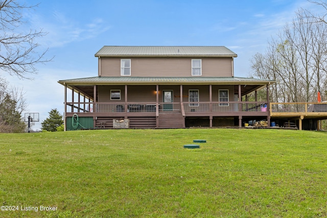 rear view of property with a lawn and covered porch