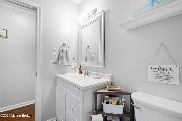 bathroom featuring vanity, hardwood / wood-style floors, and toilet