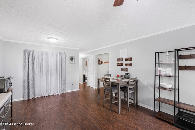 dining space featuring ornamental molding, dark wood-type flooring, a textured ceiling, and ceiling fan