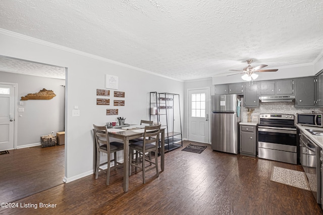 dining space featuring ceiling fan, ornamental molding, a textured ceiling, and dark hardwood / wood-style floors