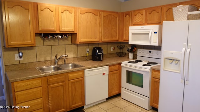 kitchen featuring backsplash, sink, white appliances, and light tile patterned floors