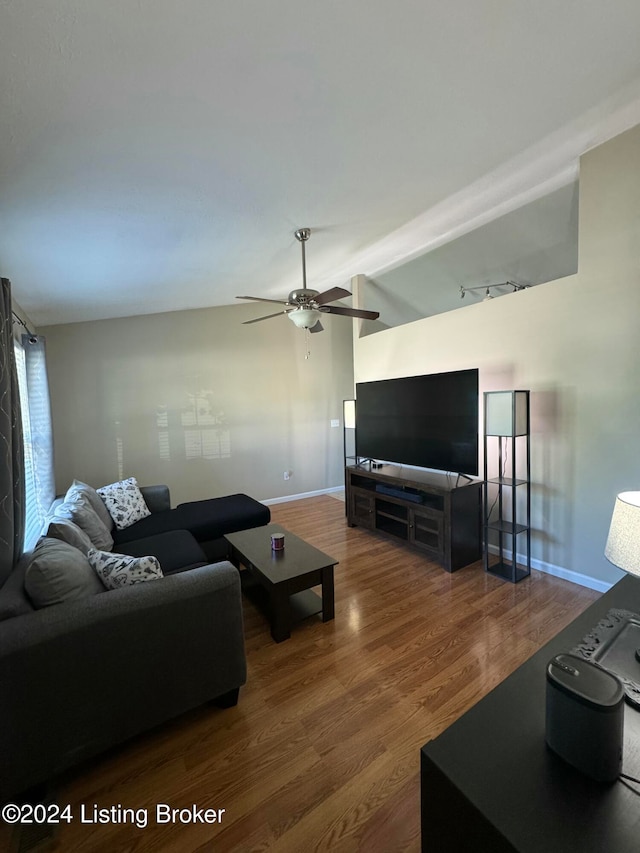 living room featuring ceiling fan, hardwood / wood-style flooring, and lofted ceiling