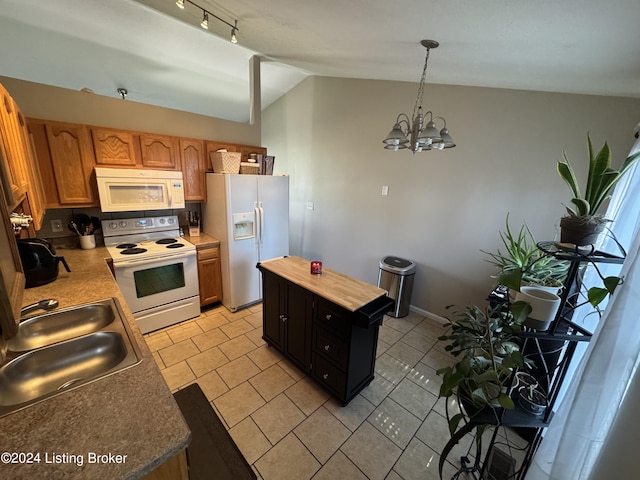 kitchen with lofted ceiling, hanging light fixtures, a notable chandelier, sink, and white appliances