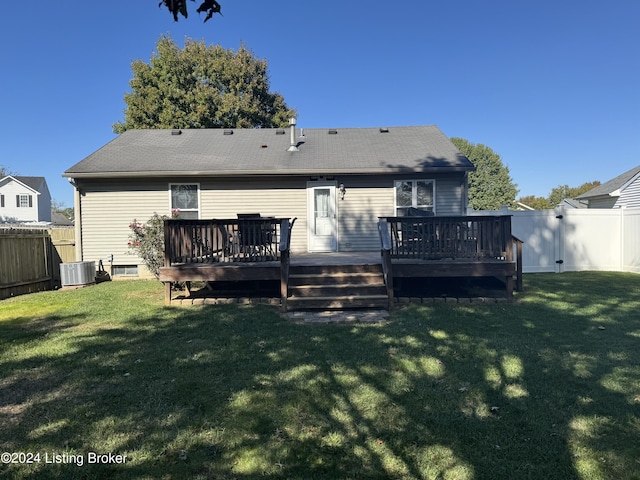 rear view of property featuring a wooden deck, a yard, and central AC unit