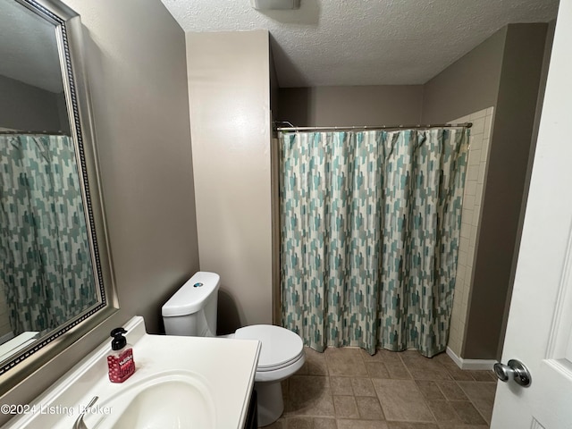 bathroom featuring vanity, a shower with shower curtain, a textured ceiling, and toilet