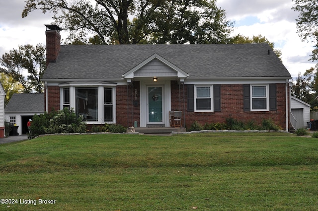 view of front of house with a front yard and a garage