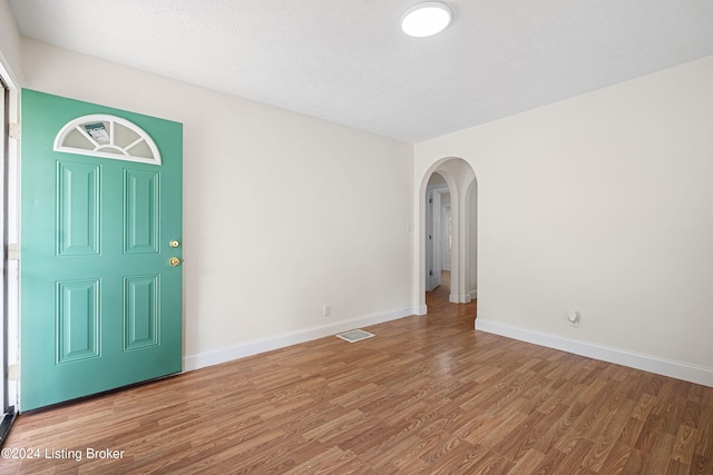 foyer with a textured ceiling and hardwood / wood-style floors