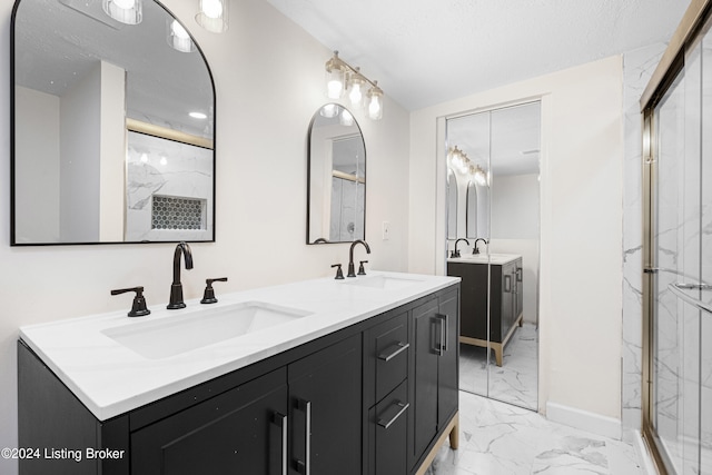 bathroom with vanity and a shower with shower door