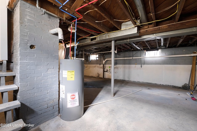 basement featuring electric water heater and a wealth of natural light