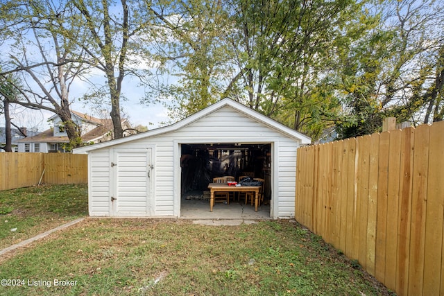 view of outbuilding featuring a lawn