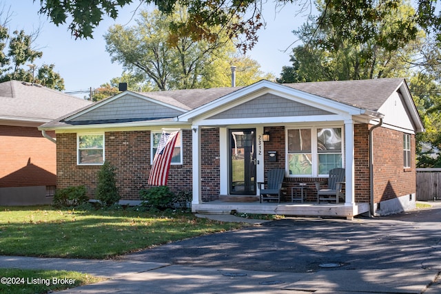 view of front of home featuring covered porch and a front lawn