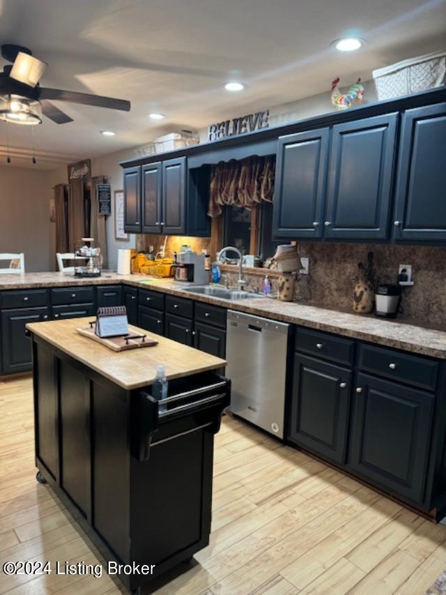 kitchen with light hardwood / wood-style floors, sink, ceiling fan, stainless steel dishwasher, and a center island