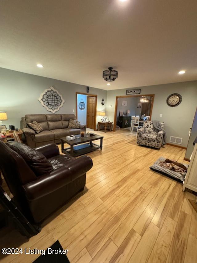 living room featuring recessed lighting, visible vents, and light wood-style floors