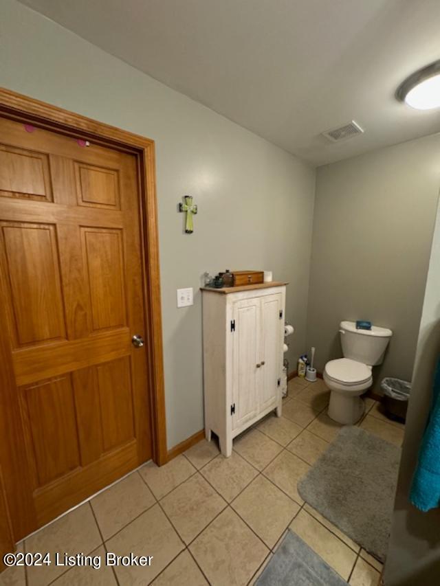 bathroom featuring tile patterned flooring and toilet