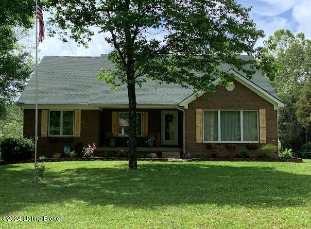 view of front of home featuring covered porch and a front yard