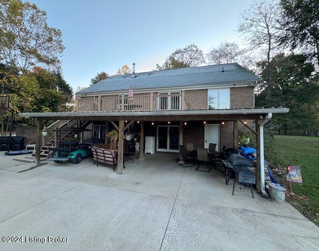 rear view of property featuring a patio area and a carport