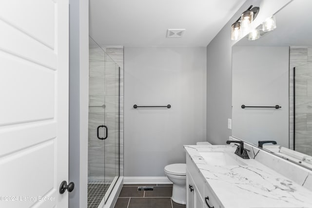 bathroom with vanity, toilet, tile patterned floors, and walk in shower