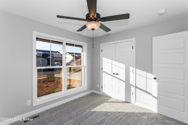 spare room with carpet and ceiling fan