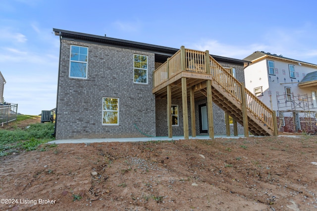 back of property featuring central AC and a deck