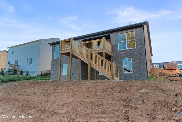 rear view of house featuring a wooden deck