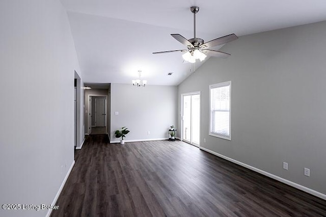 spare room featuring lofted ceiling, dark hardwood / wood-style flooring, and ceiling fan with notable chandelier