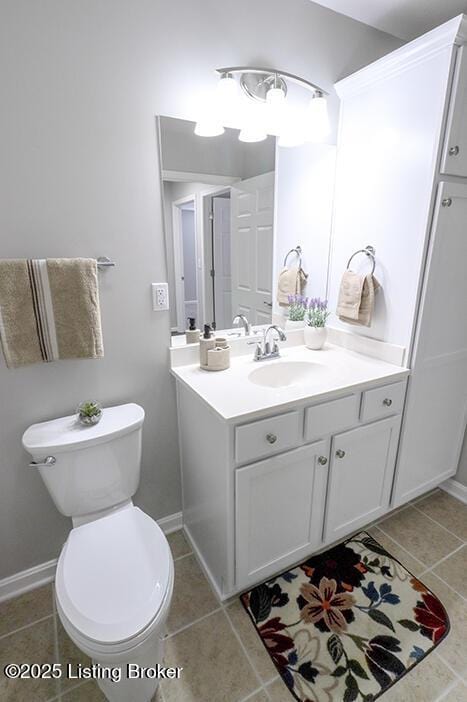 bathroom featuring tile patterned flooring, vanity, and toilet