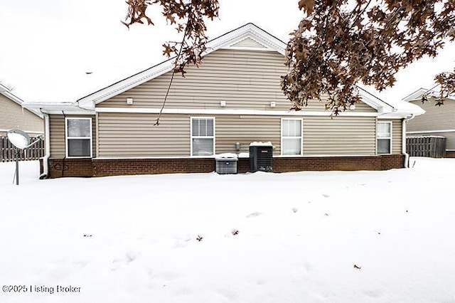 view of snow covered back of property