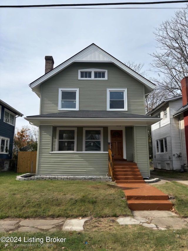 view of front of house with covered porch and a front lawn