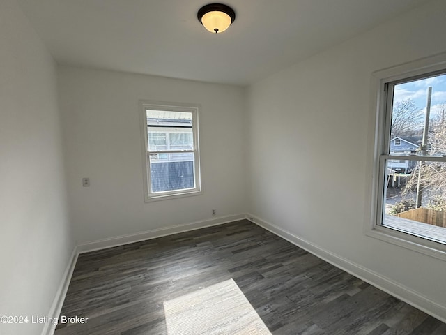 empty room with dark wood-type flooring