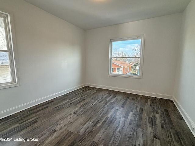 spare room with dark hardwood / wood-style flooring