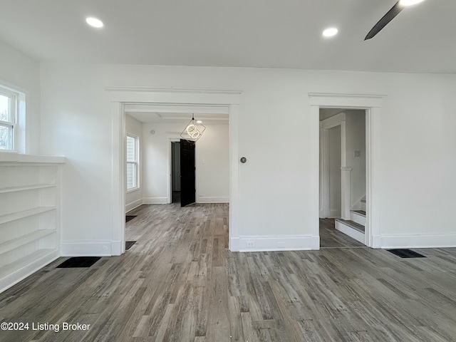 spare room with hardwood / wood-style floors, plenty of natural light, and ceiling fan