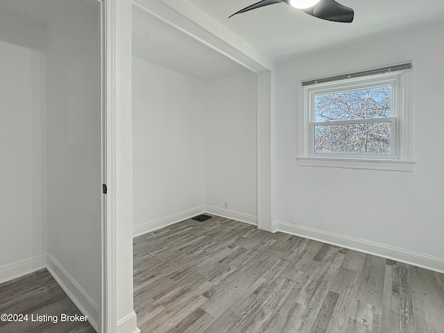 empty room featuring ceiling fan and light wood-type flooring