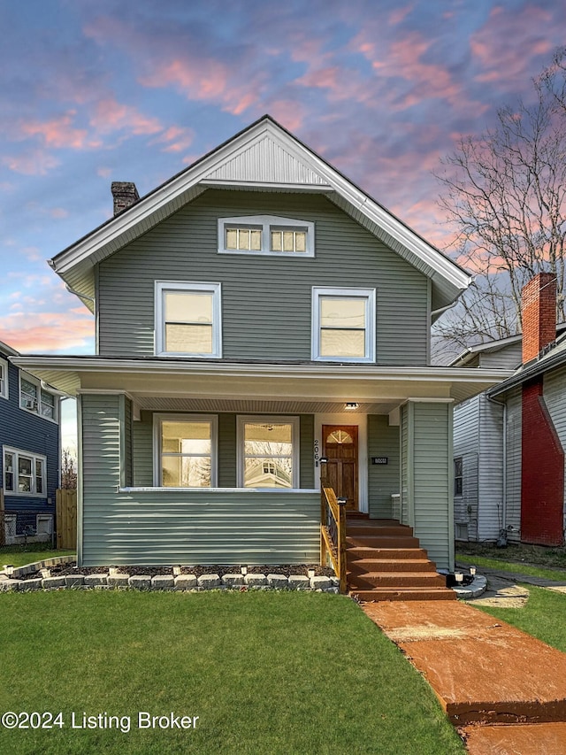 view of front of house featuring a lawn and a porch