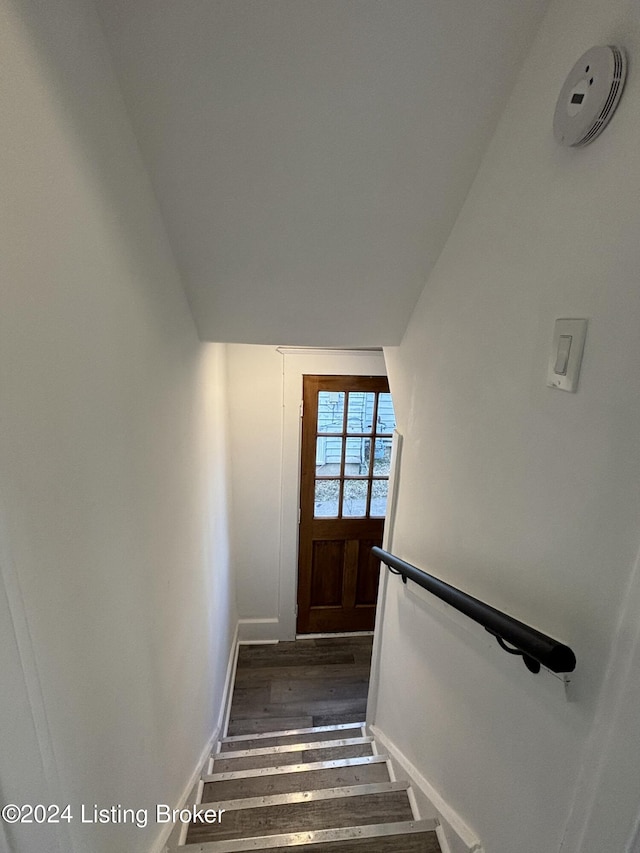 stairs featuring wood-type flooring