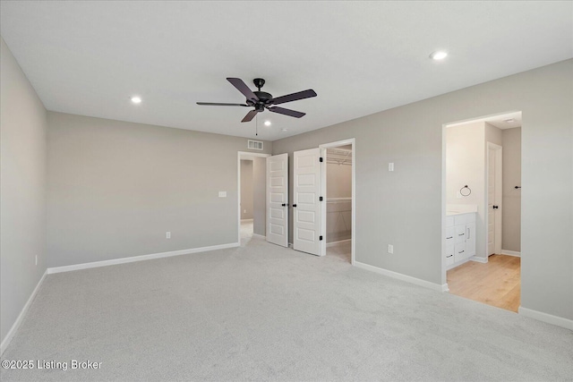 8801 Legendary Ln, Louisville, KY 40229 - unfurnished bedroom with light carpet, recessed lighting, baseboards, a walk in closet, and ensuite bathroom