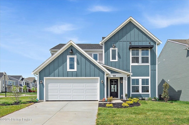 8801 Legendary Ln, Louisville, KY 40229 - view of front of home with driveway, board and batten siding, a front yard, and a garage