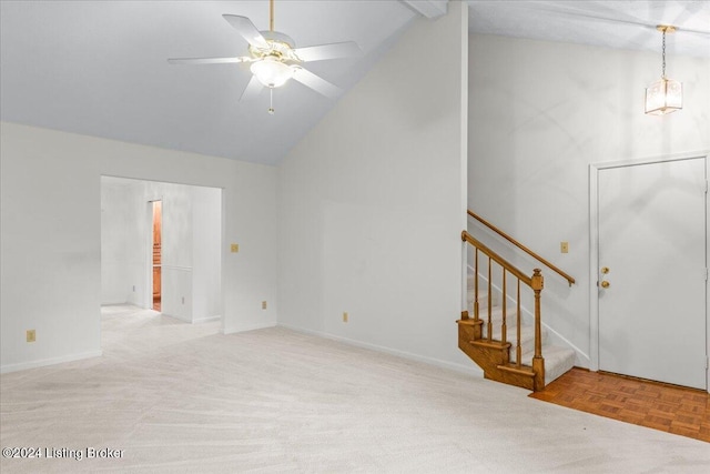 unfurnished living room featuring ceiling fan, vaulted ceiling, and light colored carpet