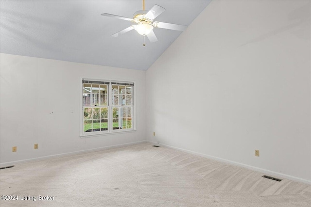 carpeted empty room featuring vaulted ceiling and ceiling fan