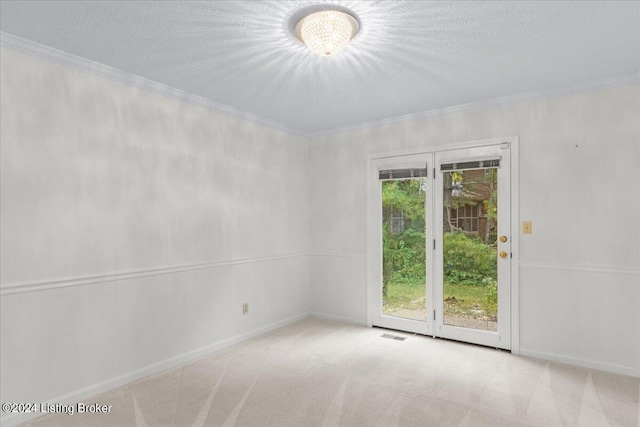 empty room featuring ornamental molding, light colored carpet, and plenty of natural light