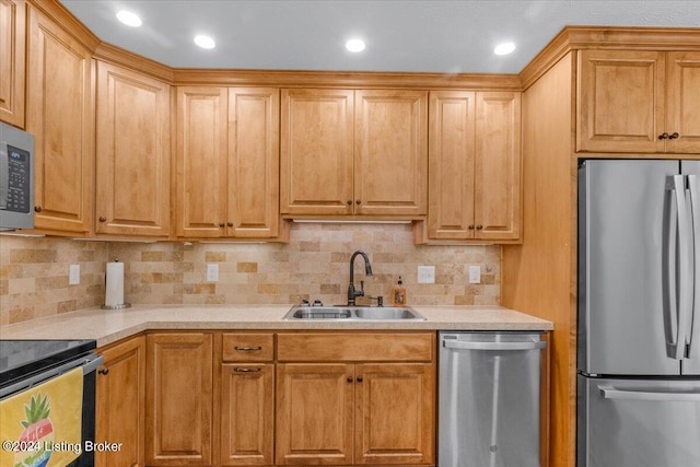 kitchen with decorative backsplash, stainless steel appliances, and sink