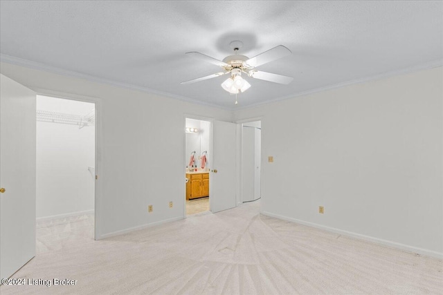 carpeted spare room with ornamental molding and ceiling fan