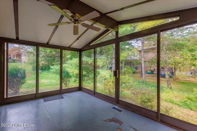 unfurnished sunroom with vaulted ceiling with beams and ceiling fan