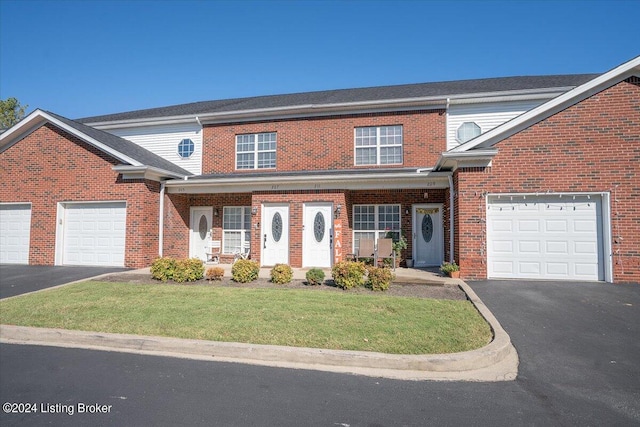 view of front of house featuring a garage and a front lawn