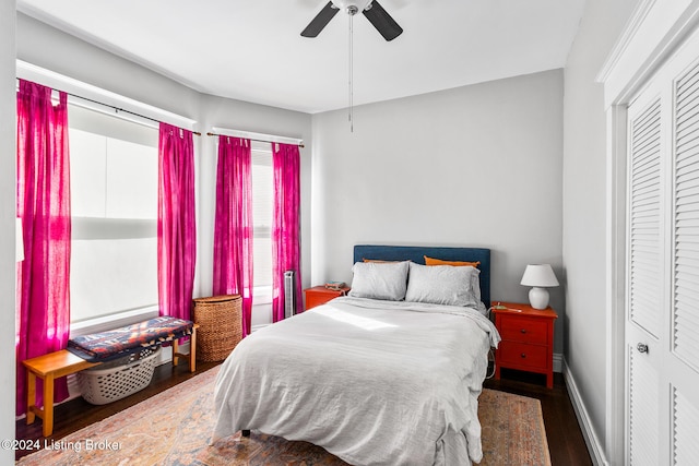 bedroom featuring dark hardwood / wood-style floors, a closet, and ceiling fan