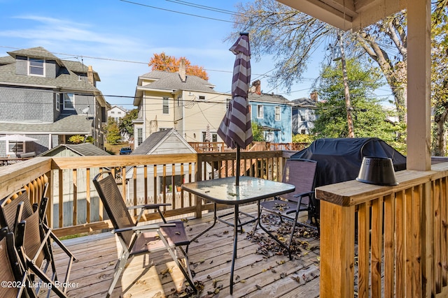 wooden terrace with area for grilling