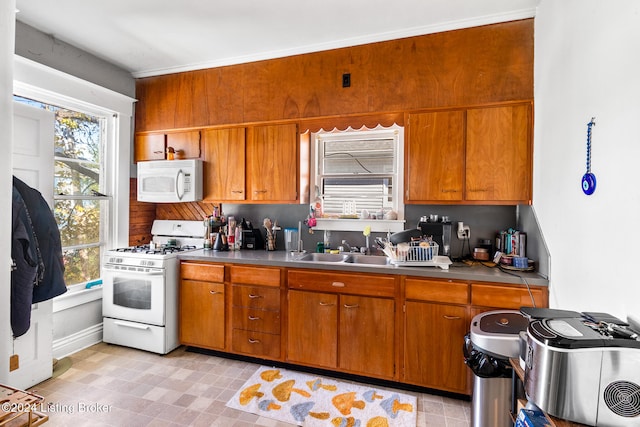 kitchen featuring white appliances, tasteful backsplash, and sink