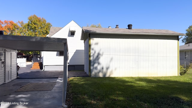 view of side of home with a yard