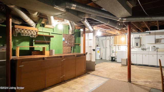 basement with water heater and separate washer and dryer