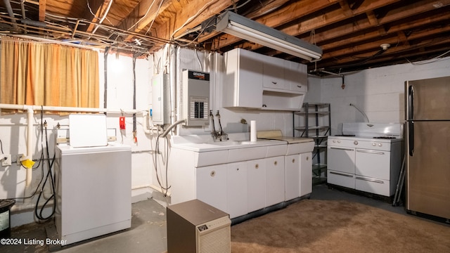 basement featuring independent washer and dryer, electric panel, and stainless steel refrigerator