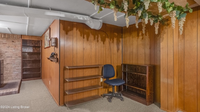 interior space featuring wooden walls and light carpet